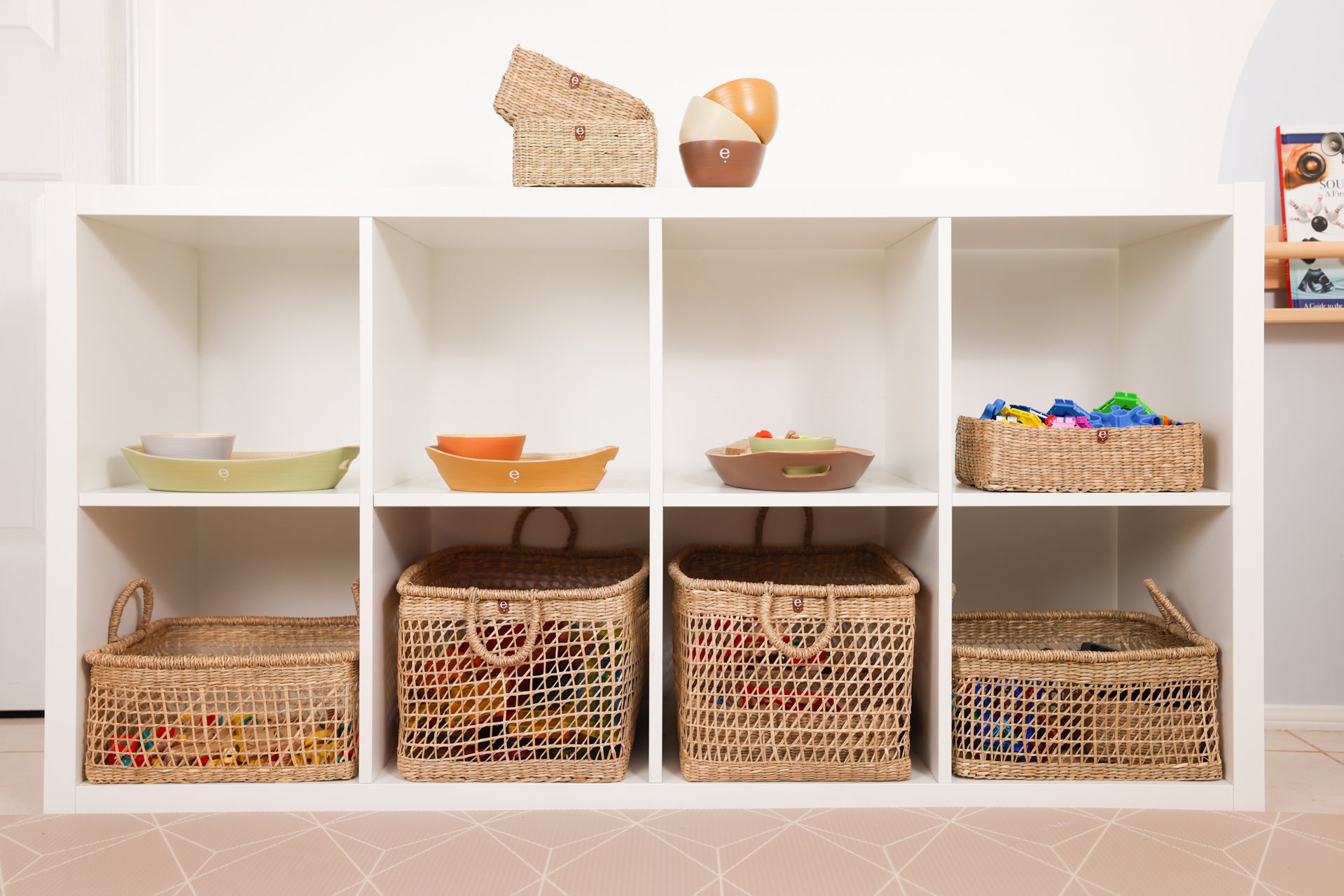 Display of natural Monetssori baskets and trays inside an IKEA Kallax shelf