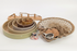 Set of woven trays and bowls on a white background